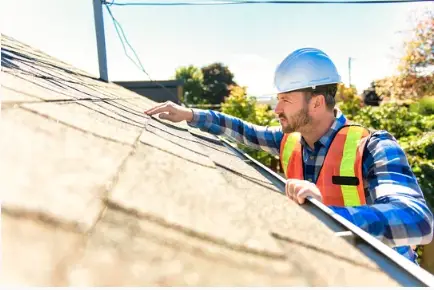 A man inspecting a roof